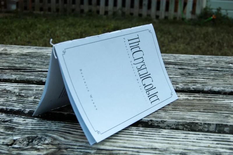 A booklet on a wood background.